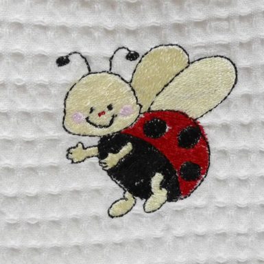 Bavoir en nid d’abeille broderie Coccinelle