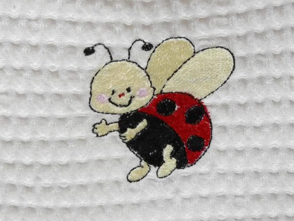 Bavoir en nid d’abeille broderie Coccinelle